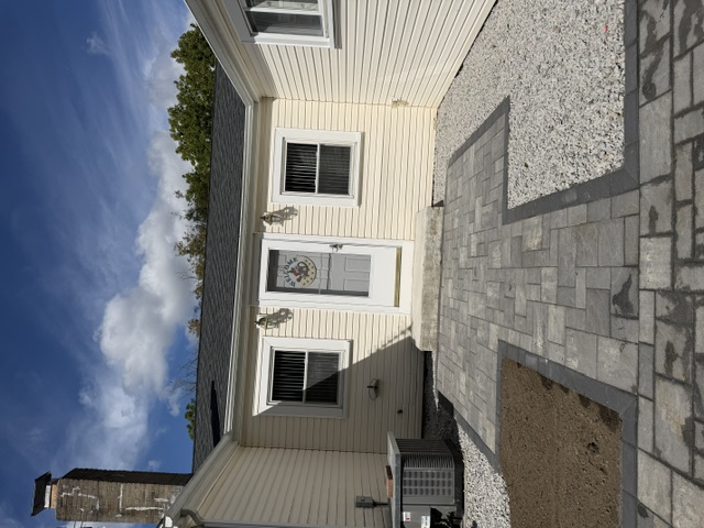 Front entrance paver patio with charcoal border replacing an old walkway in North Smithfield, RI