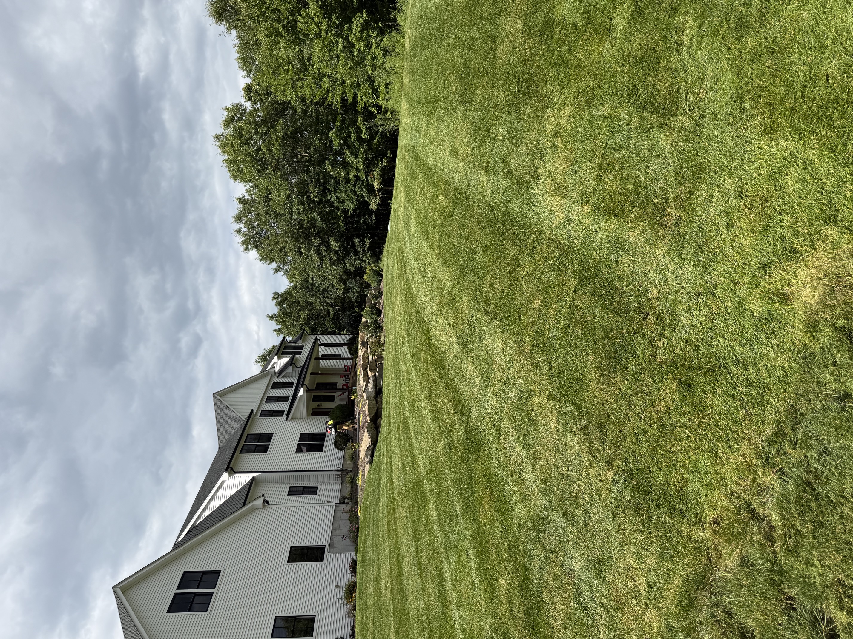Freshly mowed front lawn with clean edges at a residential home in North Smithfield, RI