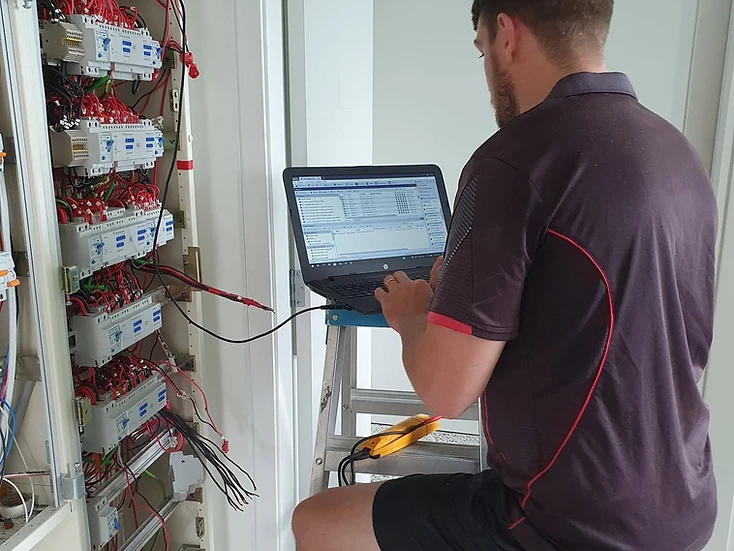 2E Electrical electrician monitoring and commissioning a residential electrical system in Hamilton