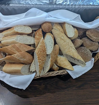 A basket of freshly baked bread and rolls ready to go out to an event