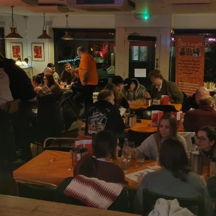 Charity quiz night with orange tablecloths
