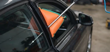 Autodeur wordt geopend met professioneel gereedschap zonder schade aan het rubber