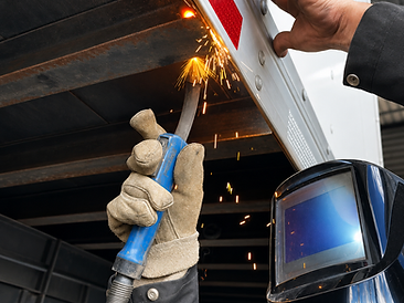 Technician welding a commercial trailer body