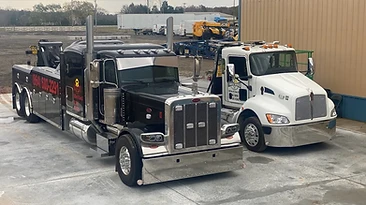 Truck World heavy-duty tow trucks parked outside the service facility