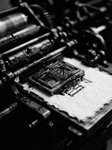 Macro detail of a printing press mid-stroke