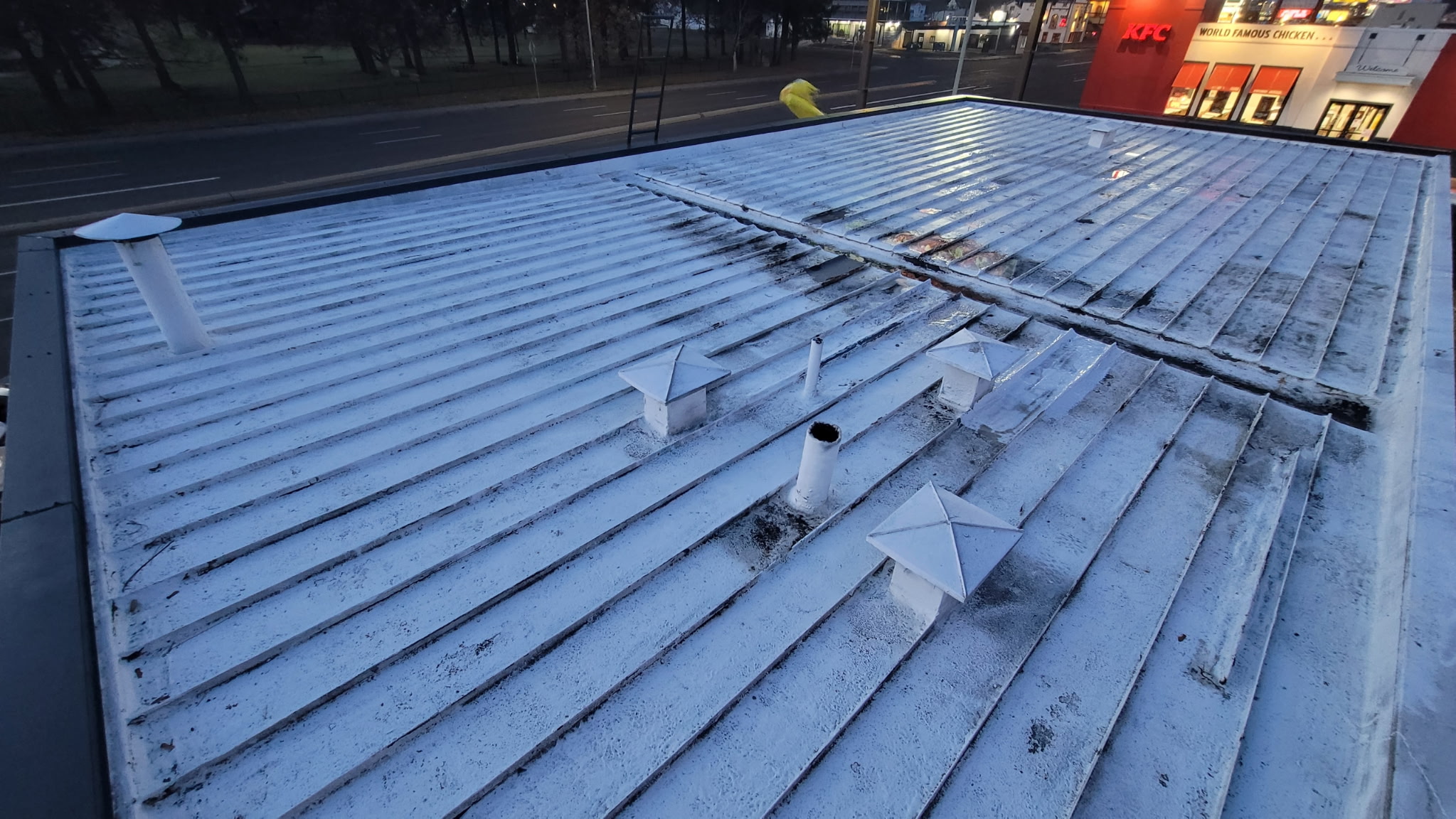 Commercial flat roof repair on a Grand Auto building