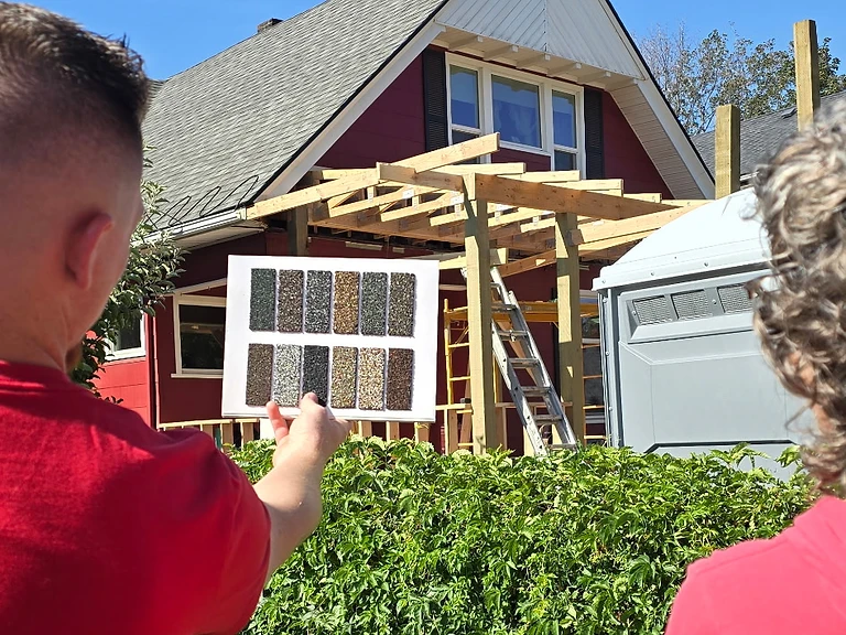 Hayden reviewing shingle color samples with Kaycee on site