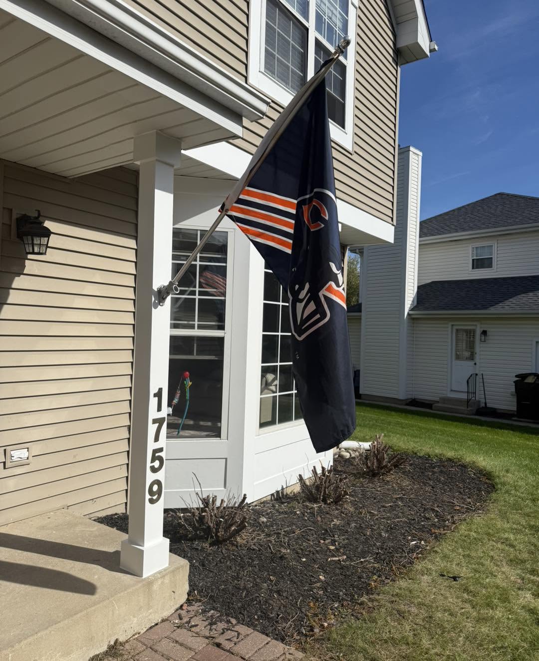 New white porch post with flag mount and house numbers by Fisher Remodeling