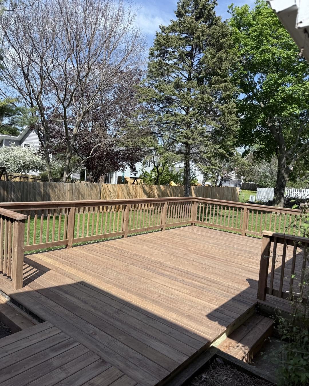 New cedar deck with corner railings by Fisher Remodeling