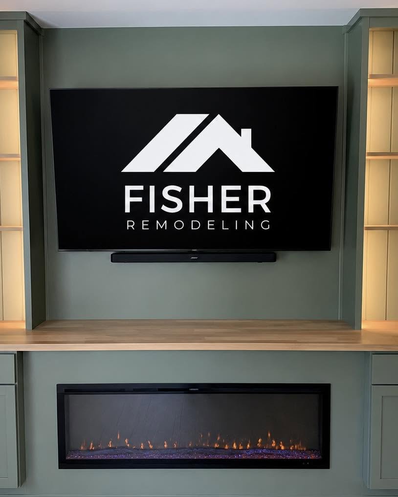 Electric fireplace with custom surround and oak shelf by Fisher Remodeling