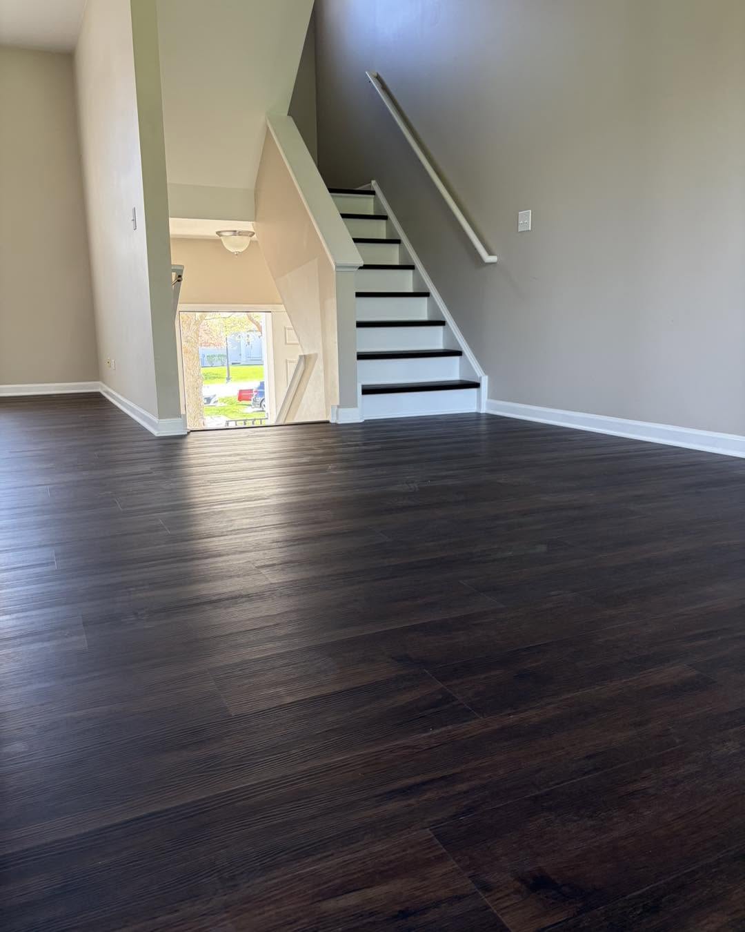 Dark vinyl plank flooring throughout an open landing by Fisher Remodeling