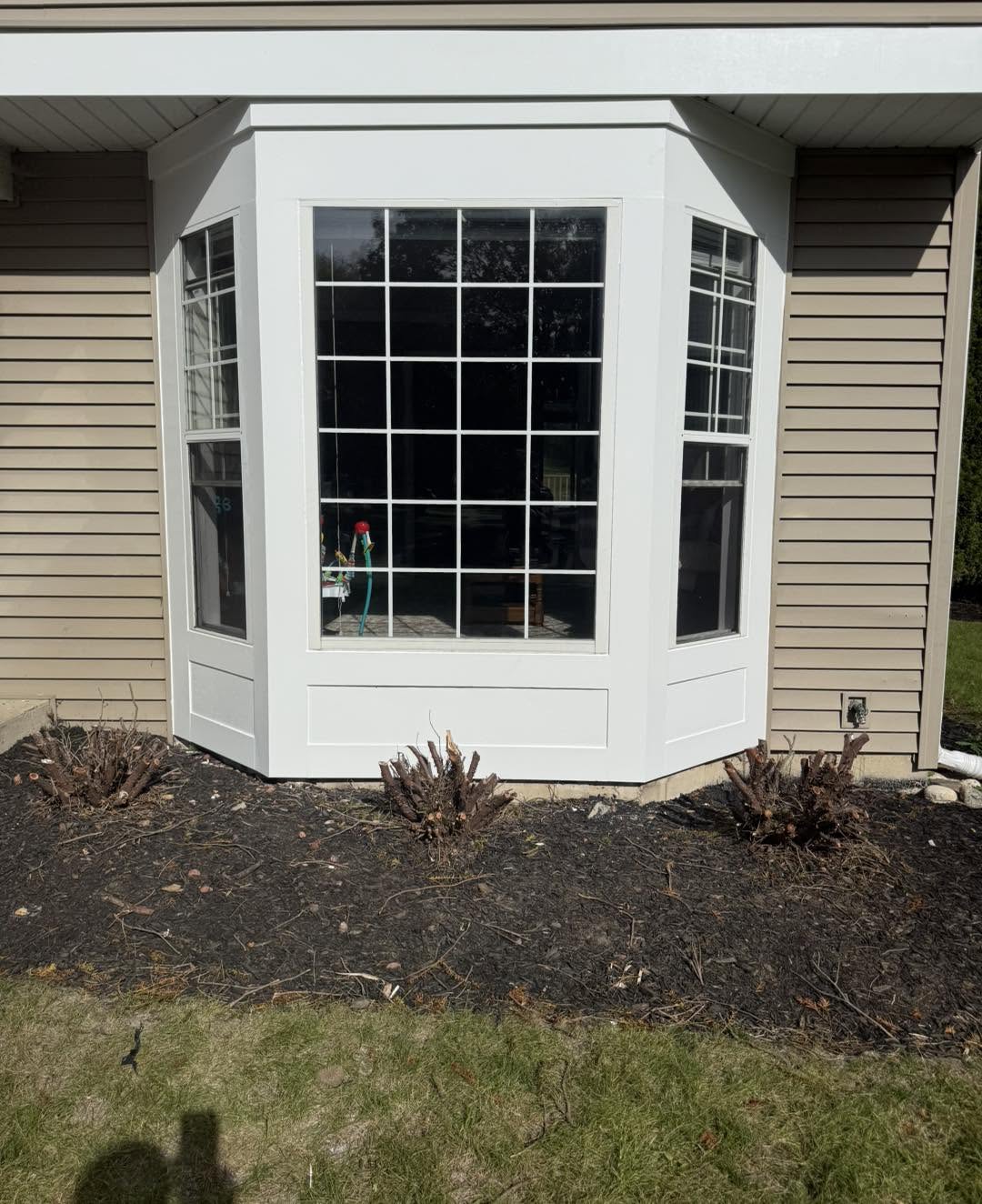 New bay window with grid panes and finished base by Fisher Remodeling