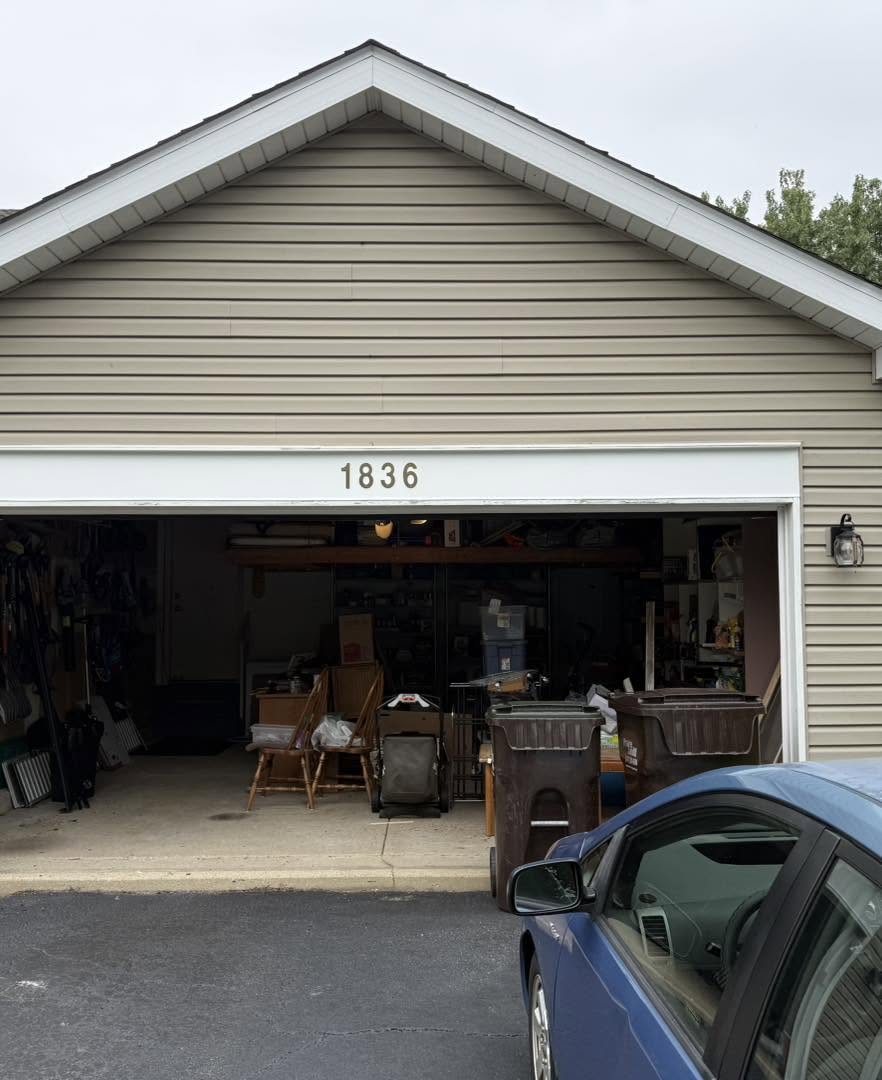 Garage exterior before siding and trim update by Fisher Remodeling