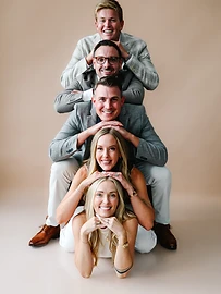 The HE Dental team stacked in a totem pose