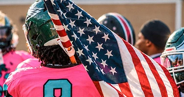 Football player carrying American flag on the field