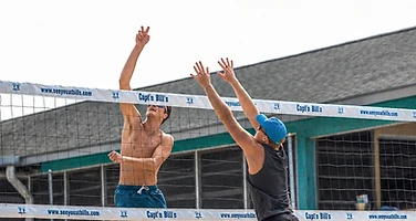 Beach volleyball match at the net