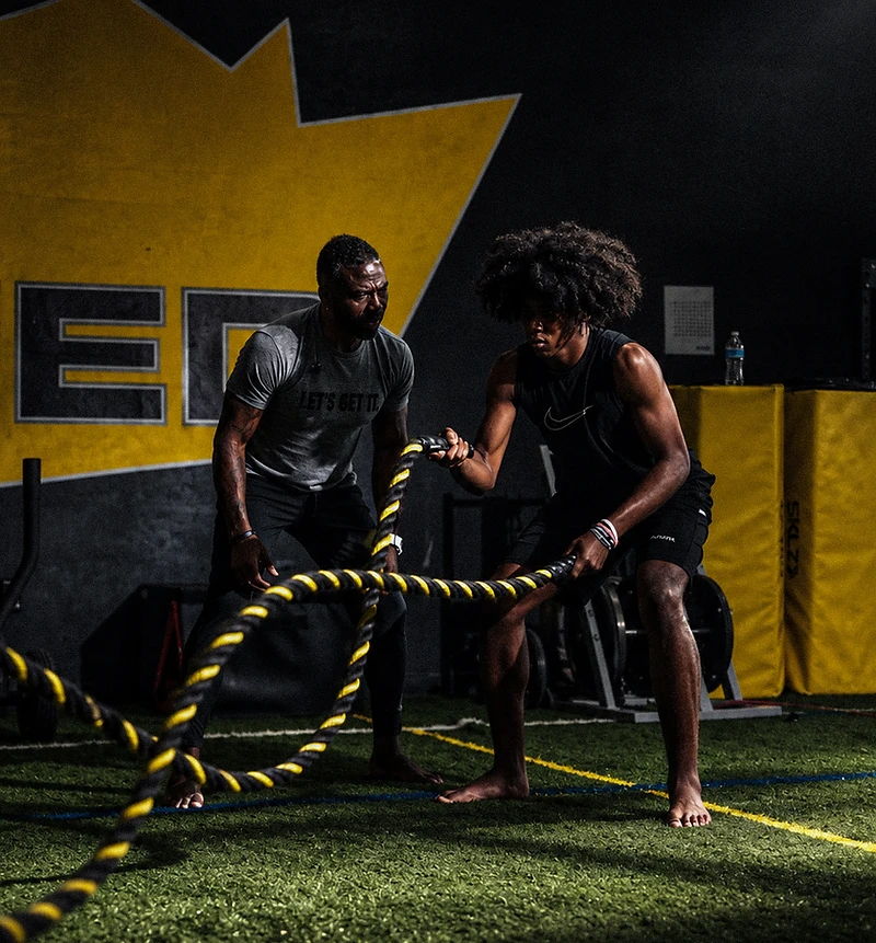 Athletes training with battle ropes