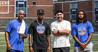Coaches and staff on the football field