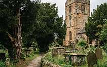 Stone-walled churchyard with church tower
