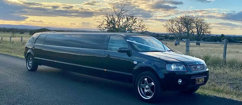 Black stretch Ford limousine at sunset