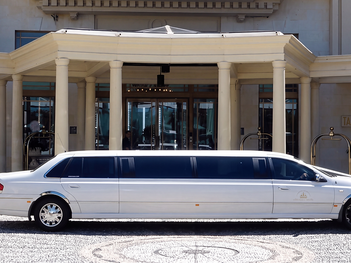 White stretch limousine outside a building