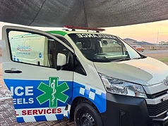 Guardian EMS ambulance with side door open on standby at base