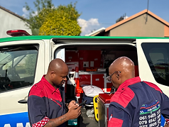 Guardian EMS medical team in uniform beside their ambulance