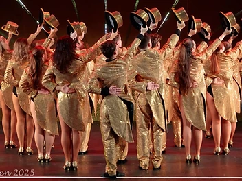 Altrincham Garrick Playhouse performers in gold tailcoat costumes during a stage production