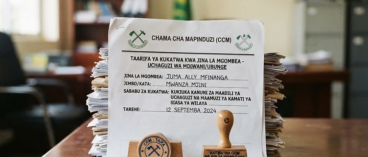 Stacks of nomination rejection notices and official party stamps sit on a wooden desk inside the CCM headquarters in Dar es Salaam.