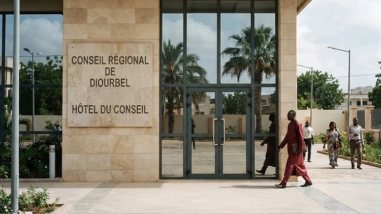 The stone-etched signage and formal entrance of the Diourbel Regional Council building in Diourbel, Senegal.