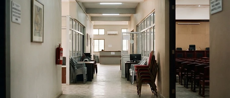 The vacant legislative committee entrance and administrative filing counters at the Montserrado County District #10 office in Sinkor show the quiet infrastructure of a governance vacuum.