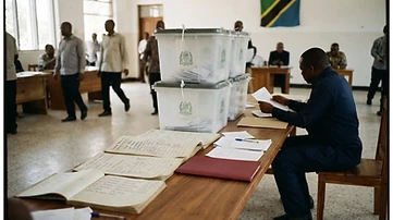 Stack of electoral ballot boxes and candidate registration ledgers in the quiet district tallying hall at the Chamwino District Council in Dodoma.