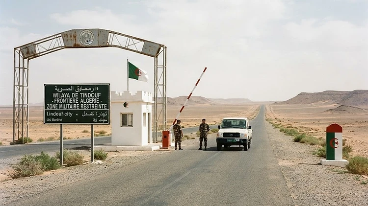 The official territorial boundary signage stands along a remote desert access road in the Tindouf province of Algeria.