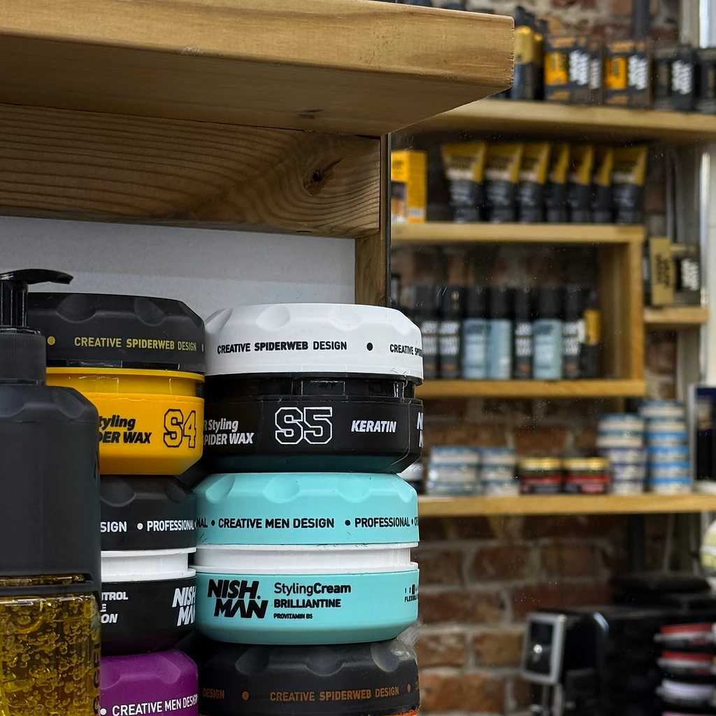 Grooming products on oak shelves in the barbershop