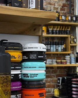 Grooming products on oak shelves in the barbershop