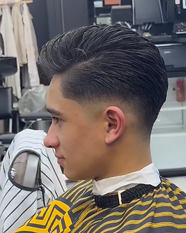 Dark slicked-back hair with a sharp fade, viewed from the side