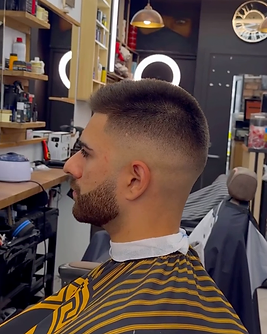 Short fade and precisely shaped beard, viewed from the side