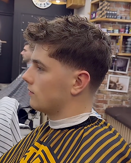 Short textured men’s haircut with a blended fade, viewed from the side