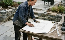 A landscaper discussing a build plan on site