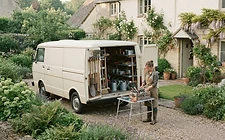 A gardener's van and tools parked on a residential job