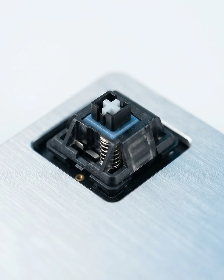 Macro photograph of a mechanical keyboard switch in a sterile white environment