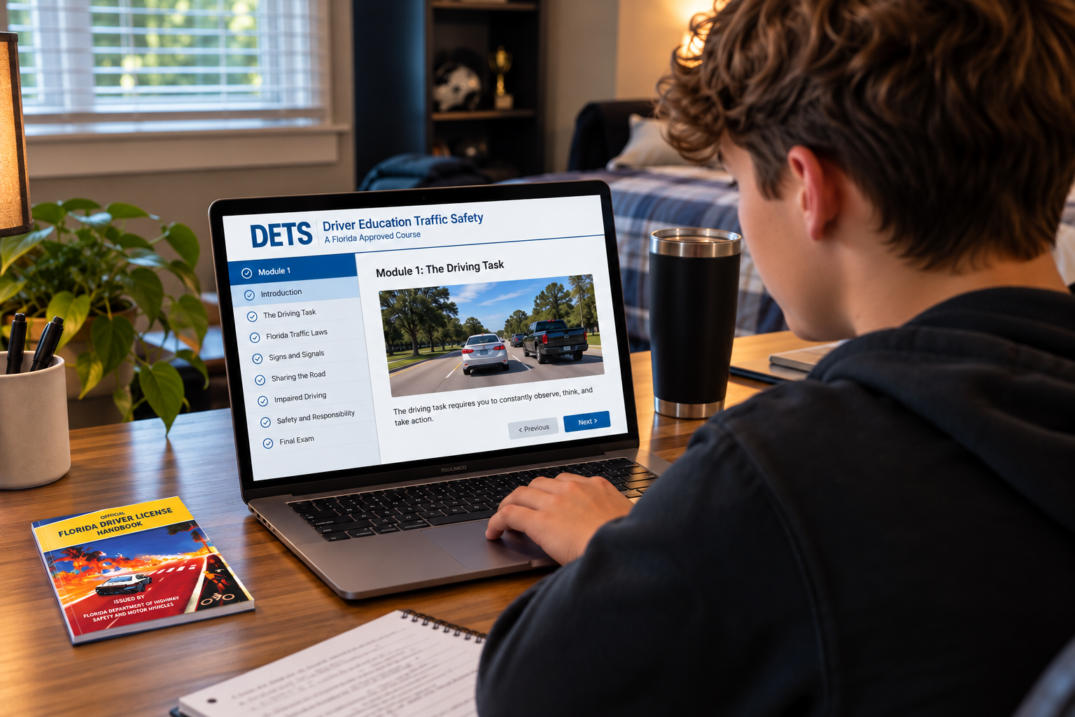Student completing a Florida-approved online driver education course at a desk with the Official Florida Driver License Handbook