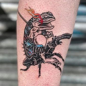 Neo-traditional colour tattoo of a toad in a Japanese-patterned robe holding a staff, riding a large dark stag beetle with flames beside it