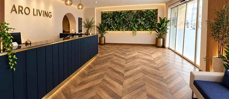 ARO Living reception desk with green plant wall in Berlin