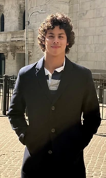 Omar Valdivia outside a stone building