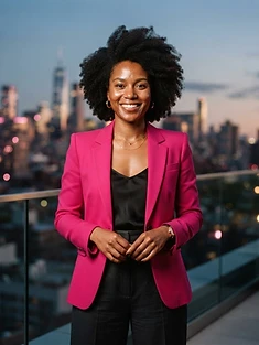 Adult woman in a fuchsia tailored jacket smiling on a rooftop at dusk