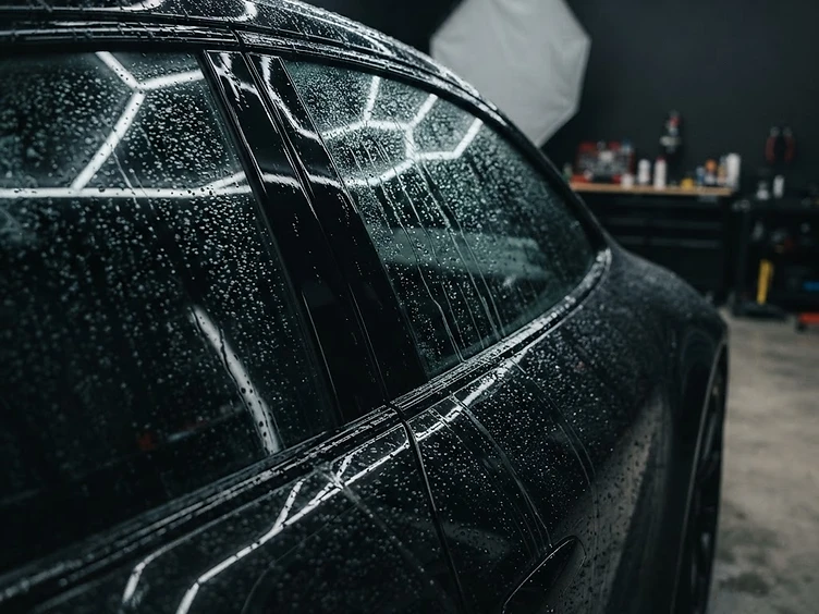 Water sheeting cleanly off coated exterior car glass in the Mack2Steam Protection shop in La Crosse, WI