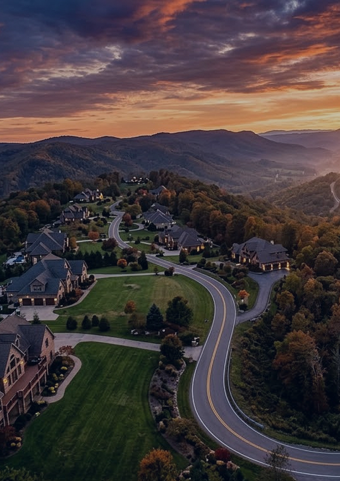 Aerial view of a wooded neighborhood at sunset