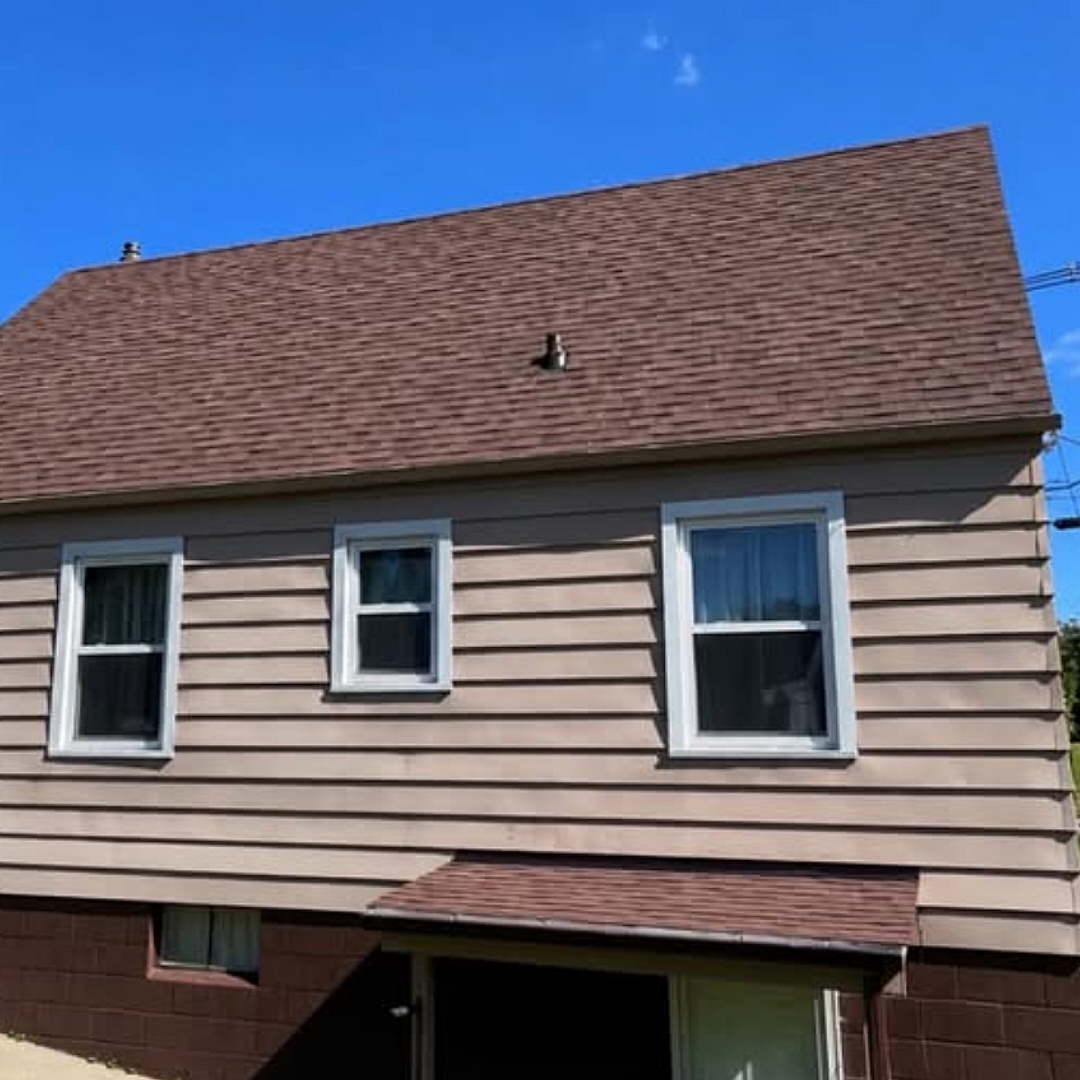 Side view of a completed dark brown shingle roof