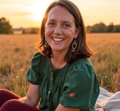 Dr. Alex Swenson-Ridley smiling in a golden field